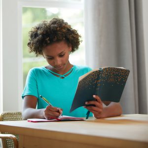 Girl reading the NKJV Youth Edition Thinline Bible