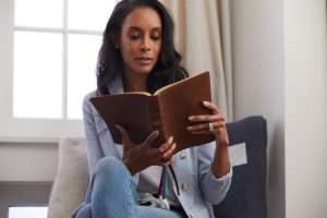 woman reading Lucado Encouraging Word BIble