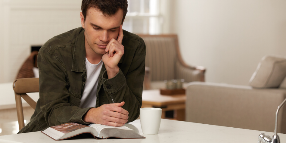 Man reading the Bible and contemplating