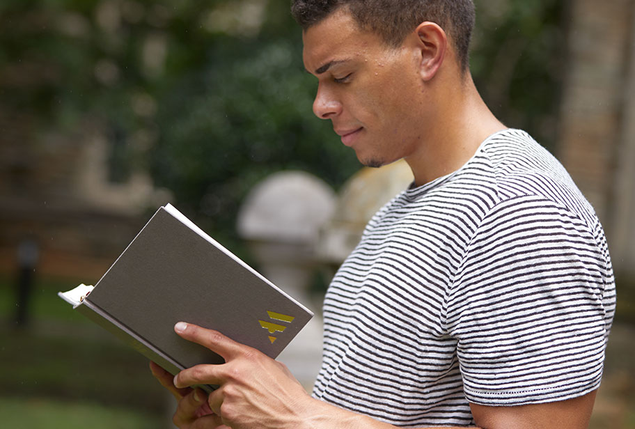 Man reading Ancient Modern Bible