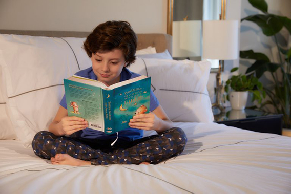 Boy reading Bedtime Devotions with Jesus Bible