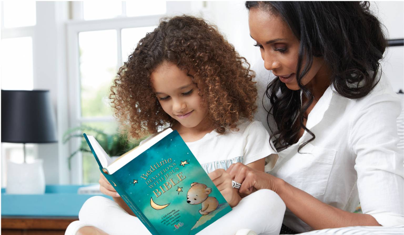 mom and child reading Bedtime devotions with Jesus Bible