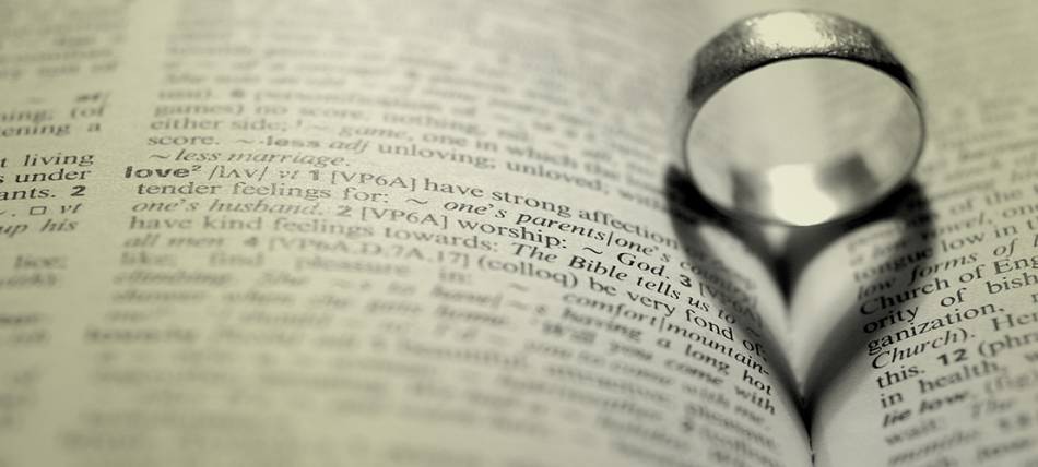 wedding ring on pages of Scripture